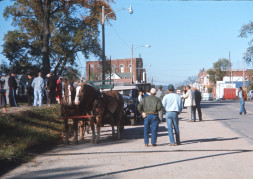 Horse and wagon, cast, and crew at side of road in downtown Fort Scott, Kansas.