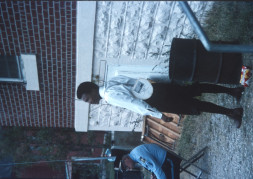 Actor Kyle Johnson (Newt Winger) standing next to garbage can outside of courthouse building from trial scene.