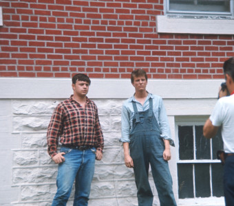 Actors being photographed outside of courthouse used in trial scene.