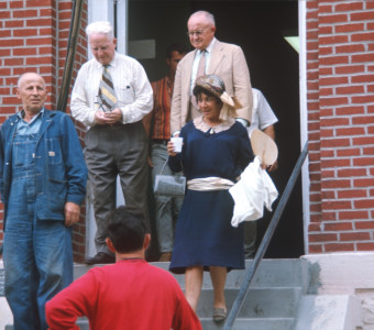 Actors exiting courthouse from trial scene.