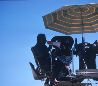 Director Gordon Parks filming a scene from above with a megaphone.