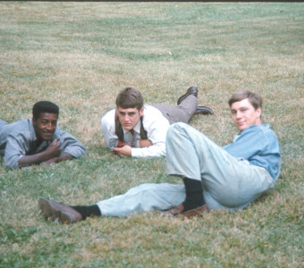 Actors laying down in the grass.