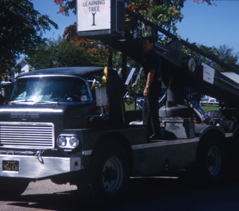 Crew member and truck with film production equipment.