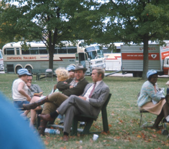 Cast, including Dan Dubbins (Harley Davis) and Dana Elcar (Kirky) seated center, in front of production vehicles.