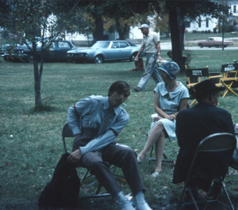 Actor Felix Nelson (Jack Winger), seated center, amongst other seated cast members.