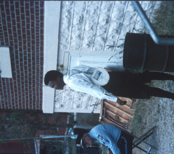 Actor Kyle Johnson (Newt Winger) standing next to garbage can outside of courthouse building from trial scene.