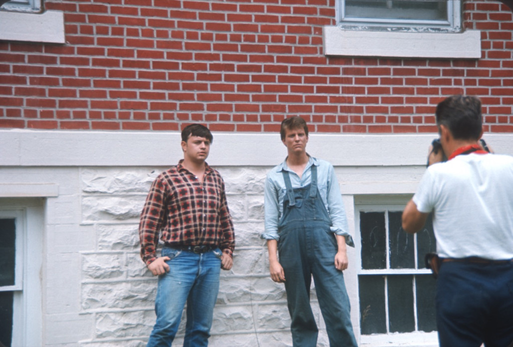 Actors being photographed outside of courthouse used in trial scene.