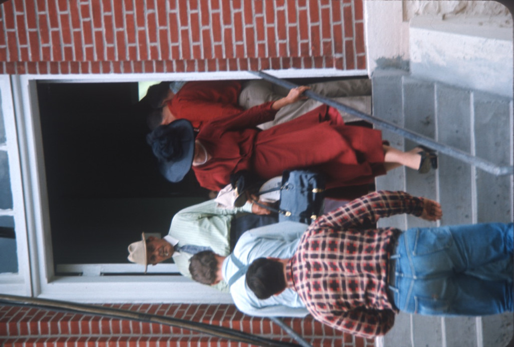 Two actors entering and two exiting the courthouse used in the trial scene.