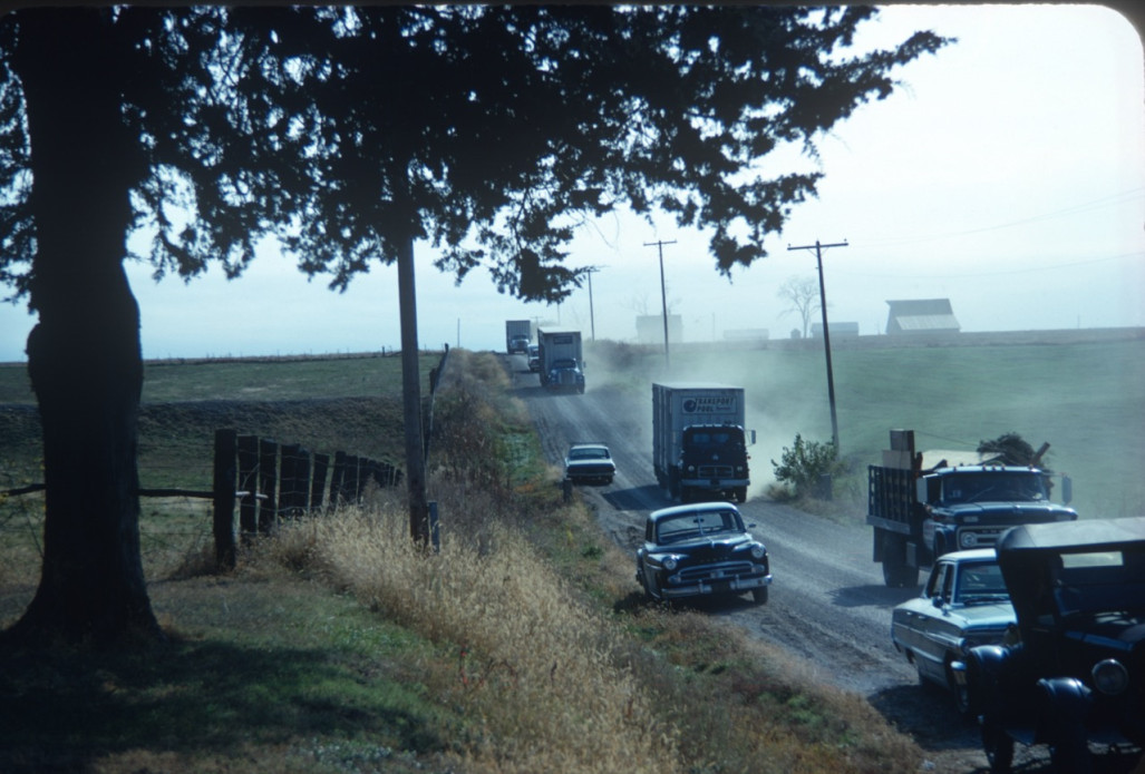 Cars and trucks with production equipment on dirt road outside of Fort Scott, Kansas near location of Winger House.