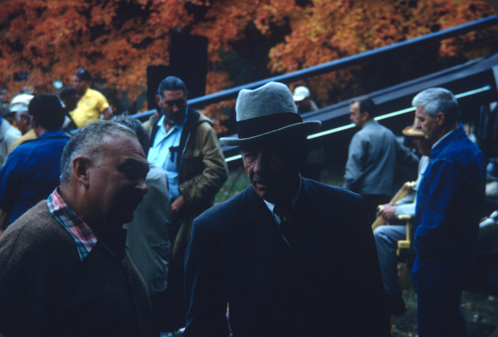 Left to right, actors Russell Thorson (Judge Cavanagh), Mira Waters (Arcella), and Carol Lamond (Big Mabel) sit in front of a production truck.