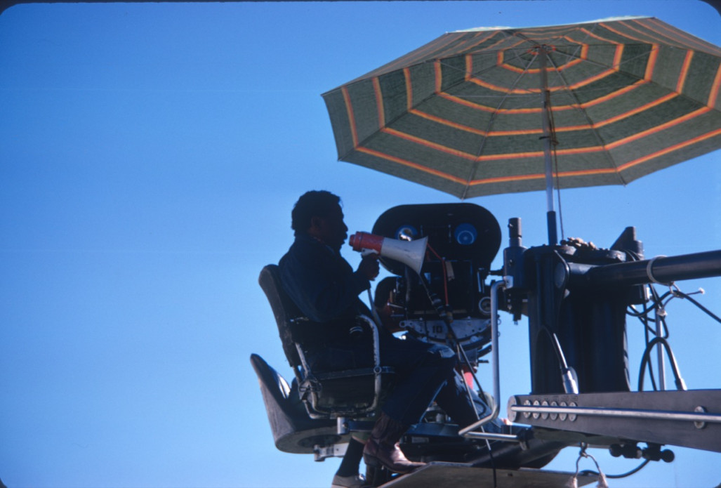 Director Gordon Parks filming a scene from above with a megaphone.