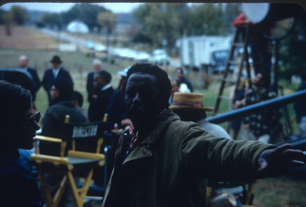 Director Gordon Parks pointing something out to crew member.