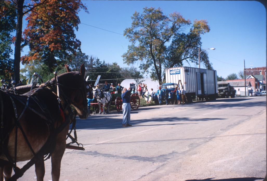 Horses and wagons with onlooks in downtown Fort Scott, Kansas during filming.