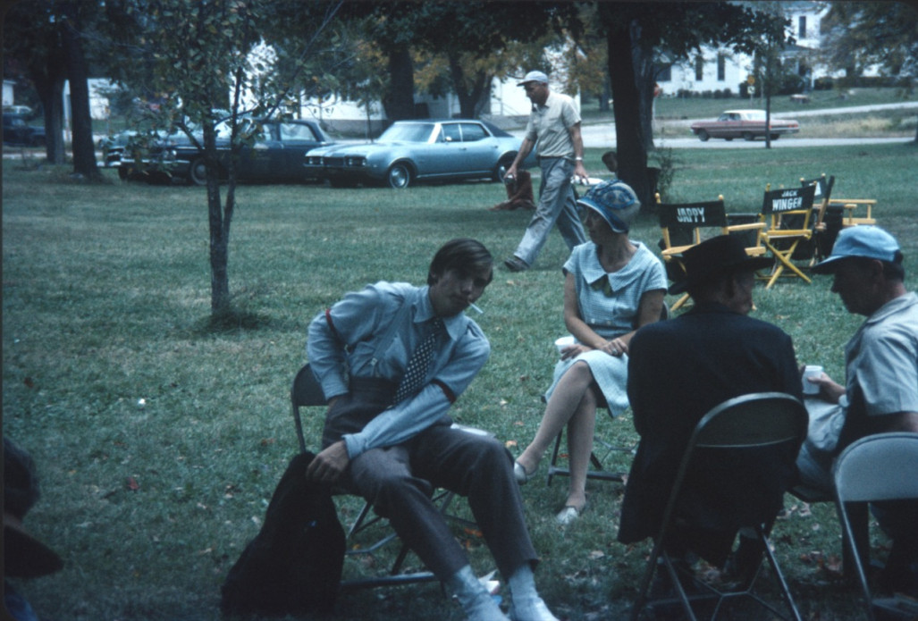 Actor Felix Nelson (Jack Winger), seated center, amongst other seated cast members.