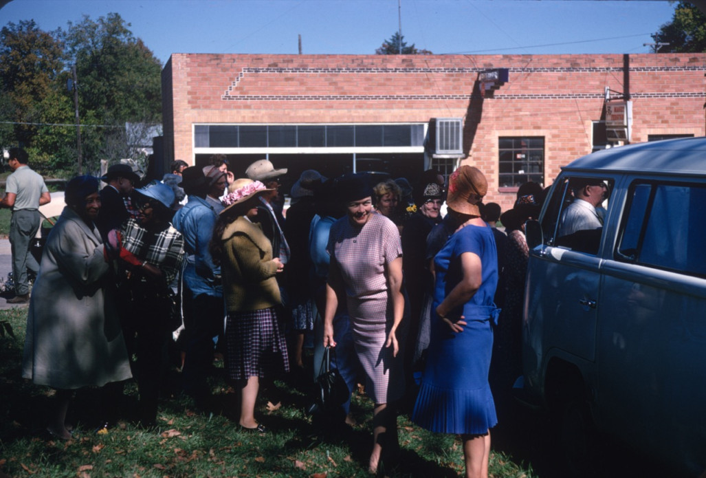 Acting cast mingling in front of a brick building in downtown Fort Scott, Kansas.