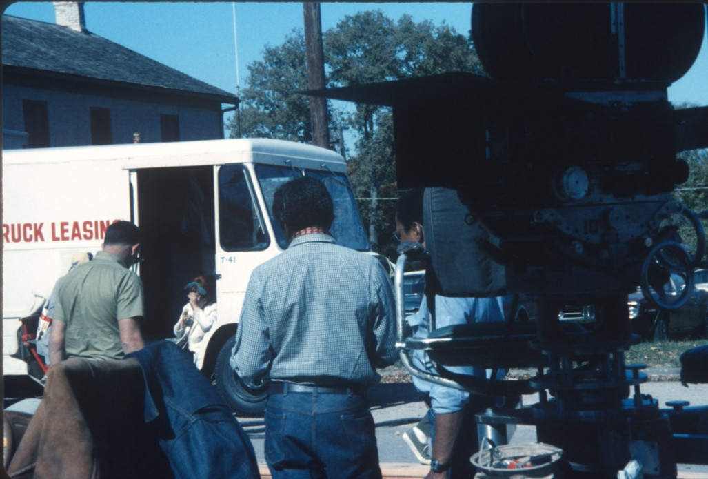 Director Gordon Parks, center and facing away from the photographer, with production crew and camera.