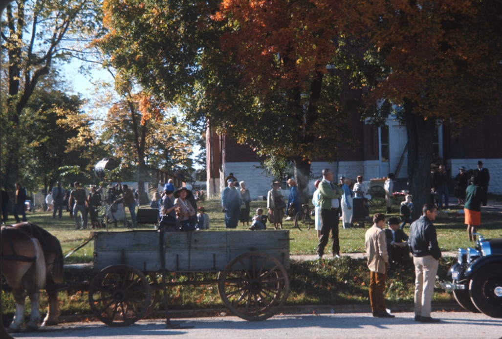 Cast and crew mingling on the lawn outside of courthouse building used for trial scene.