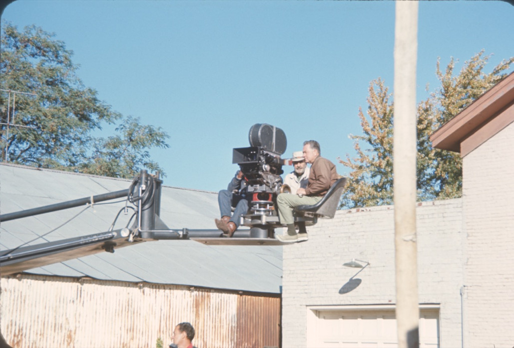 Production crew filming from above in front of a brick building in downtown Fort Scott.