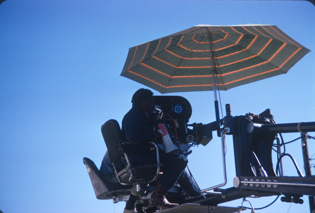 Director Gordon Parks with crew members filming from above while holding a megaphone.